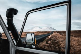 Example 2 A snow covered mountain range, viewed through the window in an open car door